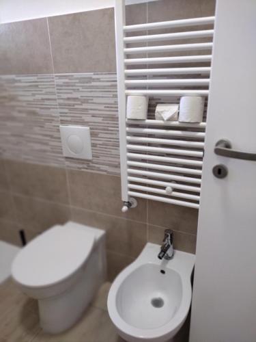 a bathroom with a white toilet and a sink at Albergo Guido Reni in Turin