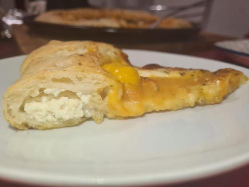 a piece of food with an egg on a white plate at Agriturismo La Collina Verde in Levanto