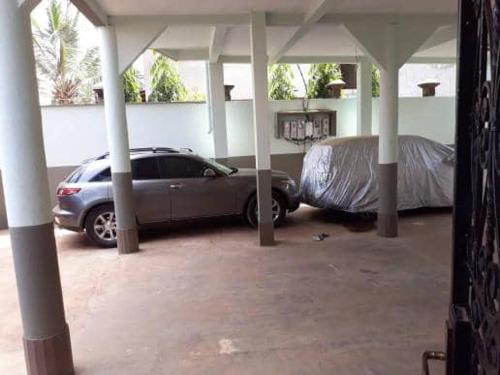 a car parked in a parking lot with a garage at Damech Apparts in Yaoundé