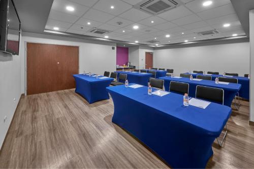 a conference room with blue tables and chairs at City Express by Marriott Torreon in Torreón