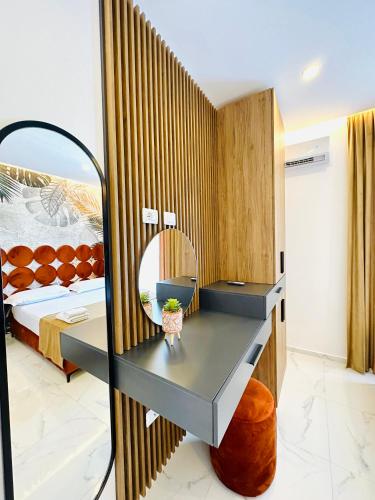 a hotel room with a mirror and a bed at Apartments Oda Hotel in Velipojë