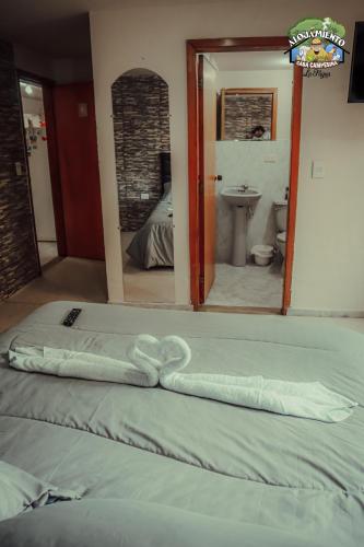 a bed with a towel on it in a room at Casa Campesina La Fagua in La Calera