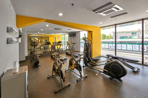 a gym with cardio equipment in a room with windows at City Express Plus by Marriott Leon Centro de Convenciones in León