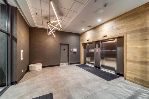 an office lobby with a hallway with elevators at Steps from downtown Calgary a Suite with a VIEW in Calgary