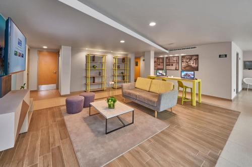 a living room with a couch and a table at City Express Suites by Marriott Ciudad de México Anzures in Mexico City