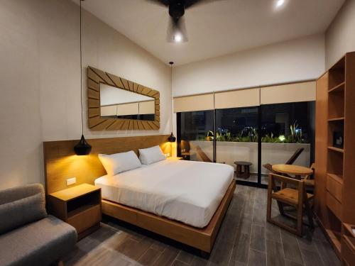 a bedroom with a bed and a couch and a chair at Sofia My Place 1 in Playa del Carmen