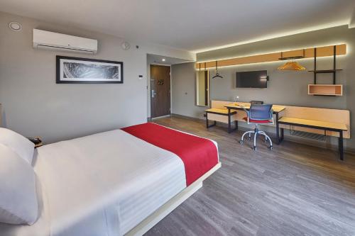 a hotel room with a large bed and a desk at City Express by Marriott Ciudad de México Tlalnepantla in Mexico City