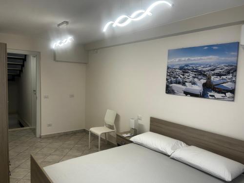 a bedroom with a bed and a desk and a chair at Casa Vacanze San Marco in San Marco dei Cavoti