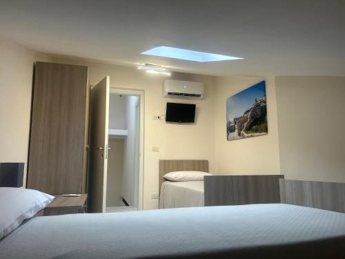 a hotel room with two beds and a blue light at Casa Vacanze San Marco in San Marco dei Cavoti