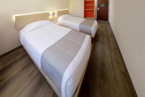 a bedroom with two beds in a room at City Express Junior by Marriott Tijuana Otay in Tijuana