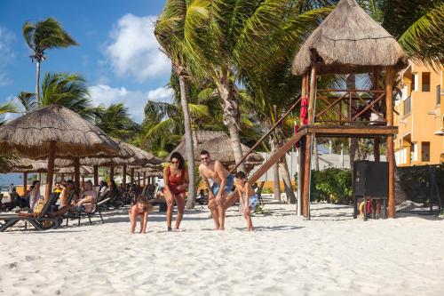 a group of people standing on a beach at The Royal Haciendas Resort & Spa in Playa del Carmen