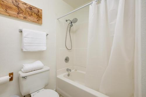 a white bathroom with a toilet and a shower at Pet-Friendly Santa Maria Condo with Balcony! in Santa Maria