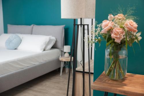 eine Vase Blumen auf einem Tisch neben einer Couch in der Unterkunft VELVET HOME PESCARA - Luxury Apartment in Pescara