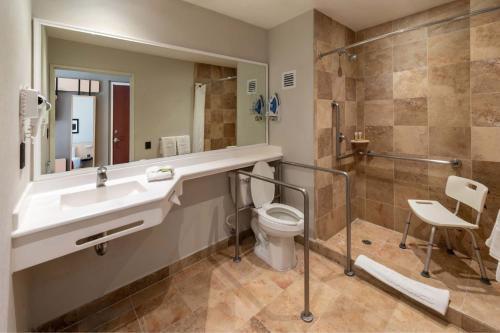 a bathroom with a sink and a toilet and a shower at City Express by Marriott Chihuahua in Chihuahua