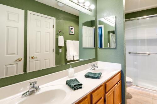 a bathroom with a white sink and a mirror at Cozy Flagstaff Retreat with Fireplace and Gas Grill! in Flagstaff