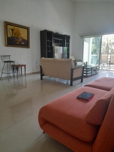 a living room with a couch and a table at airbnb Acapulco Diamante in Acapulco