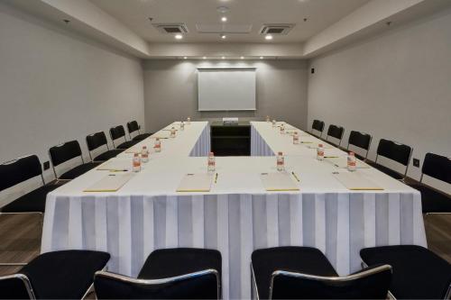 a large conference room with a white table and chairs at City Express by Marriott La Raza in Mexico City