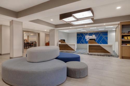 a lobby with a circular chair and a stool at Holiday Inn Express Hotel & Suites Moab, an IHG Hotel in Moab