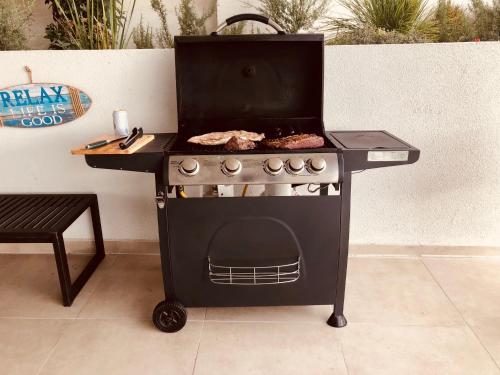 a barbecue grill with food on top of it at Departamento Banus Marbella piso 1 in Maitencillo