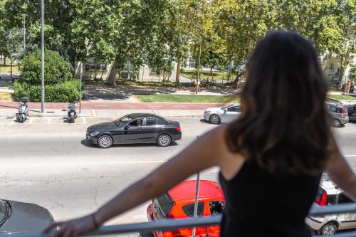 a woman is looking out of a window at a car at Mare Fuori B&B in Pescara