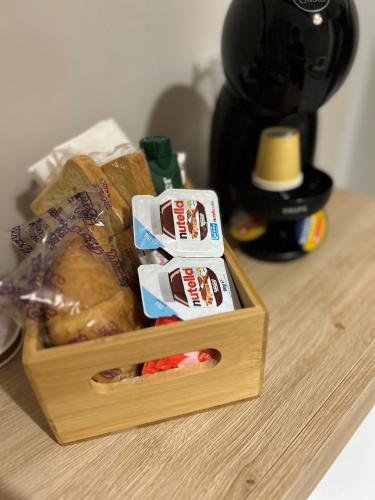 a wooden box with a loaf of bread on a table at Casa la cava in Taranto