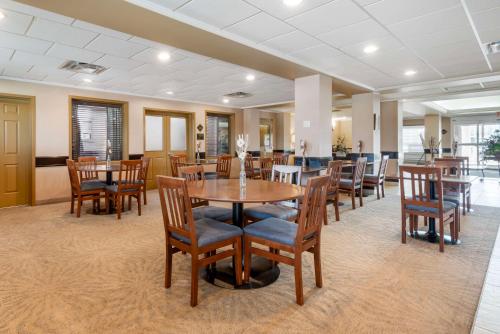 a dining room with wooden tables and chairs at Best Western Rocky Mountain House in Rocky Mountain House