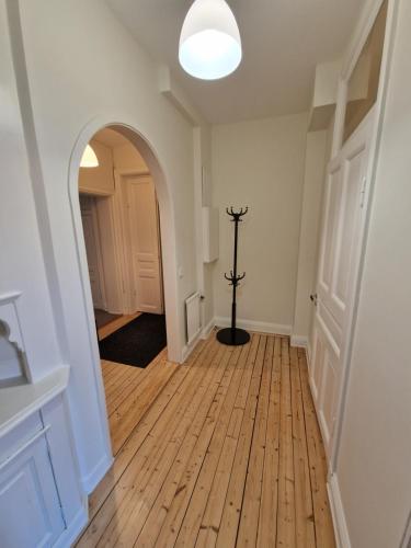 an empty hallway with an archway and a floor at Home Inn UPG76 in Stockholm