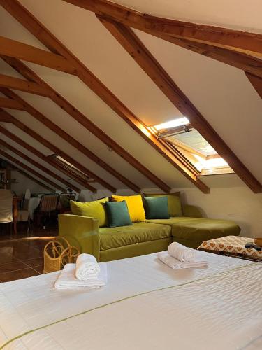 a living room with two beds and a couch at The Cozy Attic Stay in Herceg-Novi