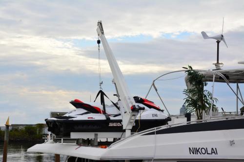 a boat being loaded with a jet ski on it at Romantic Condo @ Ocean 3-deck Yacht in Brooklyn
