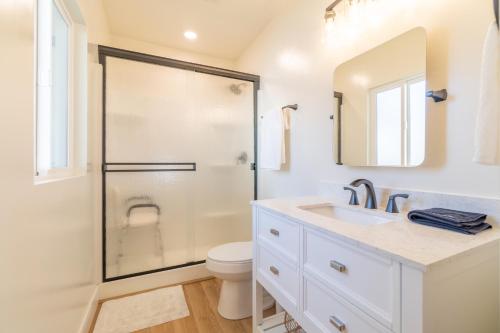 a bathroom with a shower and a toilet and a sink at Reno Oasis: Stylish 1-Bedroom Escape in Reno