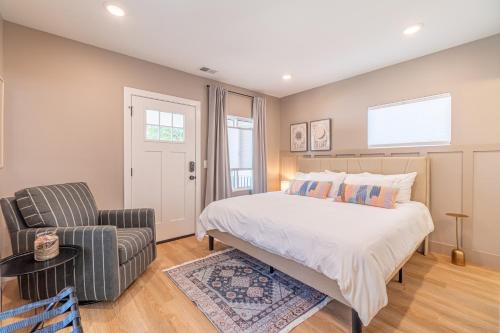 a bedroom with a bed and a chair at Reno Oasis: Stylish 1-Bedroom Escape in Reno