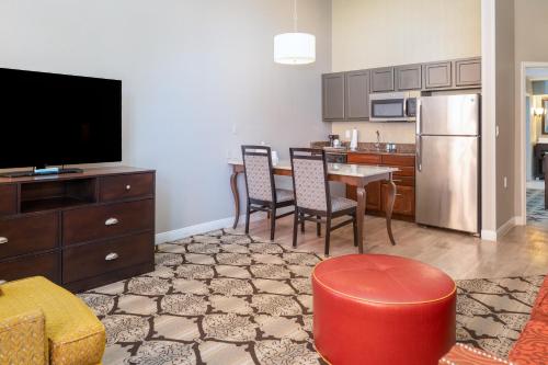 a living room with a kitchen and a dining room at Hampton Inn and Suites New Orleans Convention Center in New Orleans