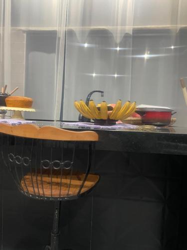 a counter with a bunch of bananas on a table at Recanto Tereza Dias in Lagoinha