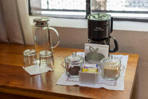 a coffee maker sitting on top of a wooden table at Meztli: Casa Boutique & Spa in Mexico City