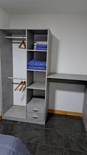 a closet with a white cabinet with shelves at MG ESQUEL in Esquel