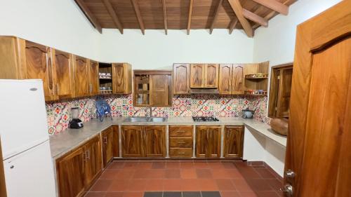 a kitchen with wooden cabinets and a tile floor at Villa Martin in Fredonia