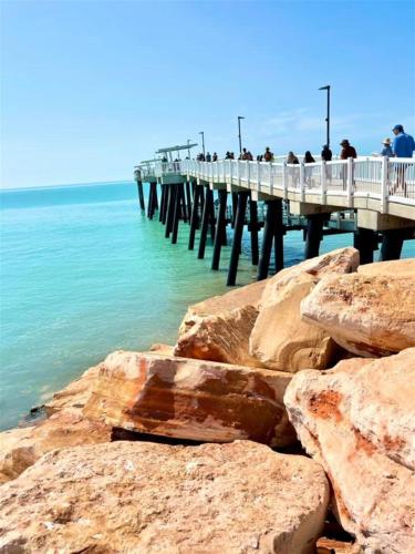 people standing on a pier over the water at Jacaranda Villa Korora Beach NSW in Kororo Basin