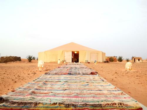 a large tent in the middle of the desert at Jardin Kotori Luxury Camp in Merzouga
