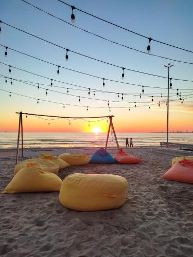 a group of surfboards on the beach at sunset at CALM Blue Sea in Durrës