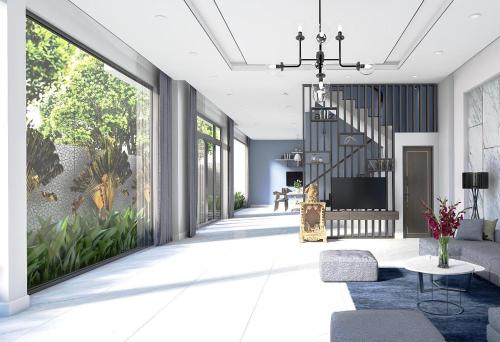 a living room with a staircase and large windows at Oscar Villa And Apartment Hoi An in Hoi An