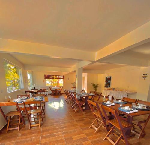 a large dining room with wooden tables and chairs at Pousada Oceano Atlântico in Marau