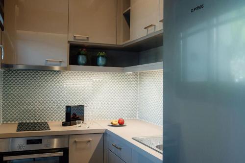 a kitchen with a plate of fruit on a counter at Iasmos Luxury Apartment in Heraklio Town
