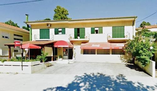 a large building with red umbrellas in front of it at My Portugal in Vidago