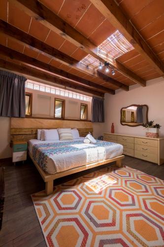 a bedroom with a large bed and a rug at Meztli: Casa Boutique & Spa in Mexico City