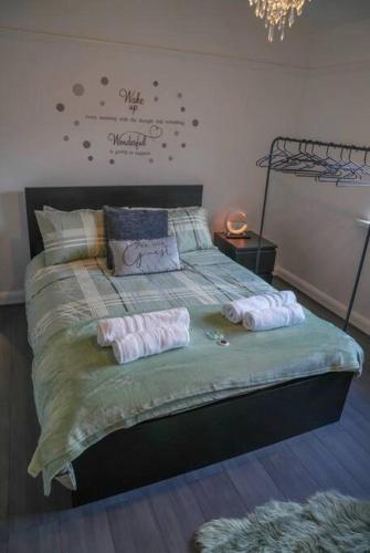 a bedroom with a bed with two towels on it at Entire home in Nottingham in Nottingham