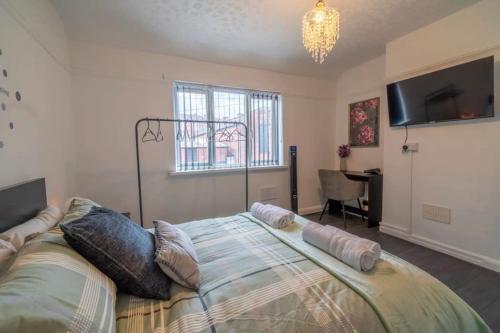 a bedroom with a bed and a window and a desk at Entire home in Nottingham in Nottingham