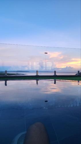 a view of a body of water with the sunset at Tablas Seaview Homestay in Ferrol