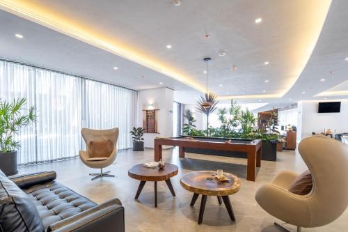 a living room with a pool table and chairs at City Express Plus by Marriott San Luis Potosi in San Luis Potosí