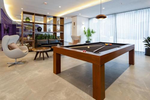 a living room with a pool table in it at City Express Plus by Marriott San Luis Potosi in San Luis Potosí