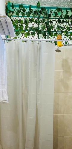 a bathroom with a white shower curtain in a bathroom at Villas Cairo in Guatemala